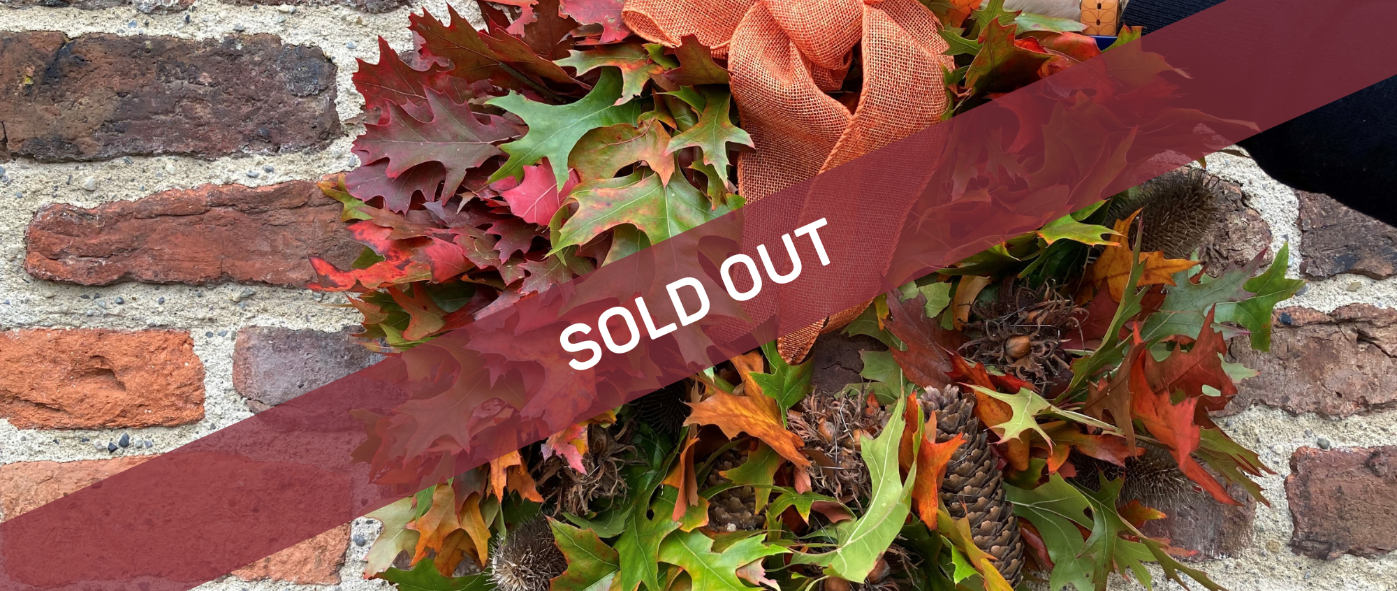 Wreath on a brick wall with text