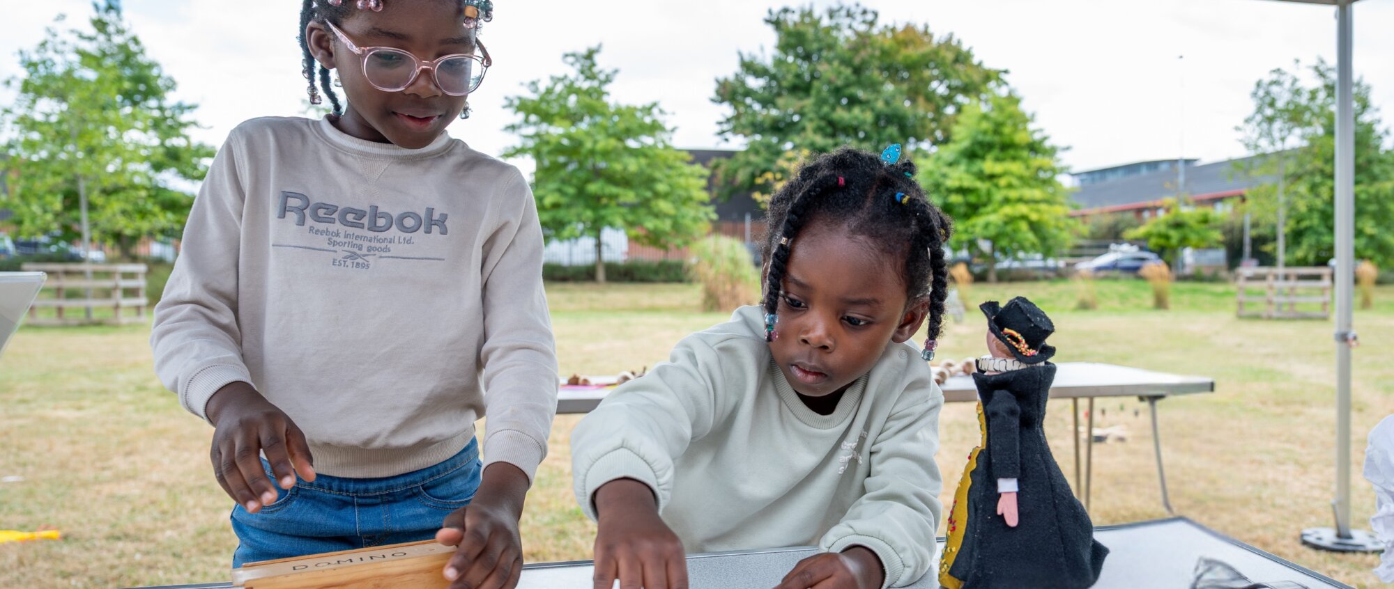 Two children are playing games on a table
