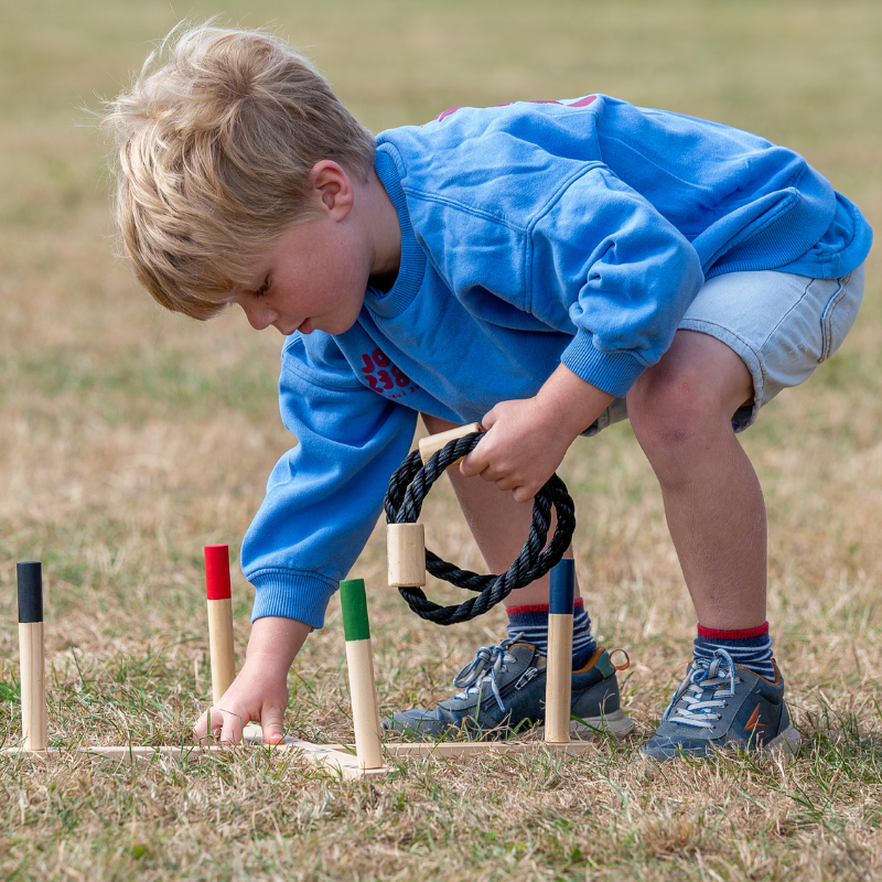 Child playing game outside on grass