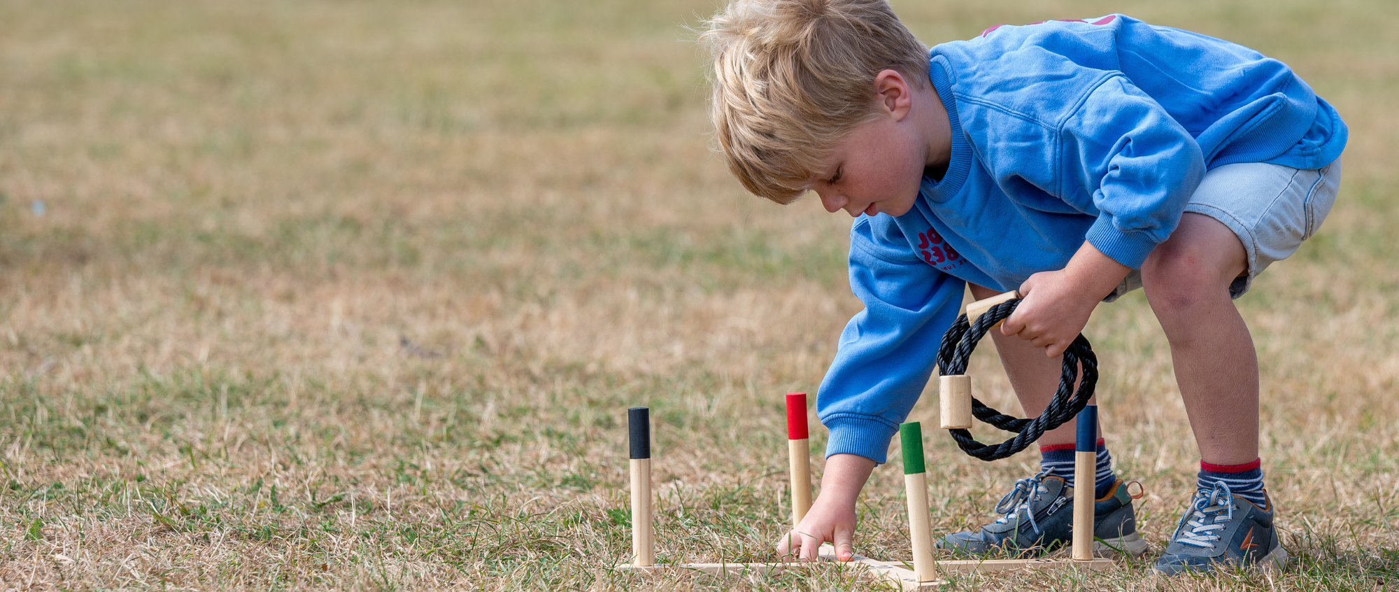 Child playing game outside on grass